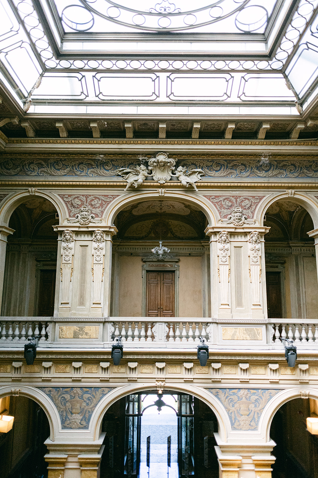 Ornate balconies, arches and glass ceiling inside Villa Erba, Lake Como.