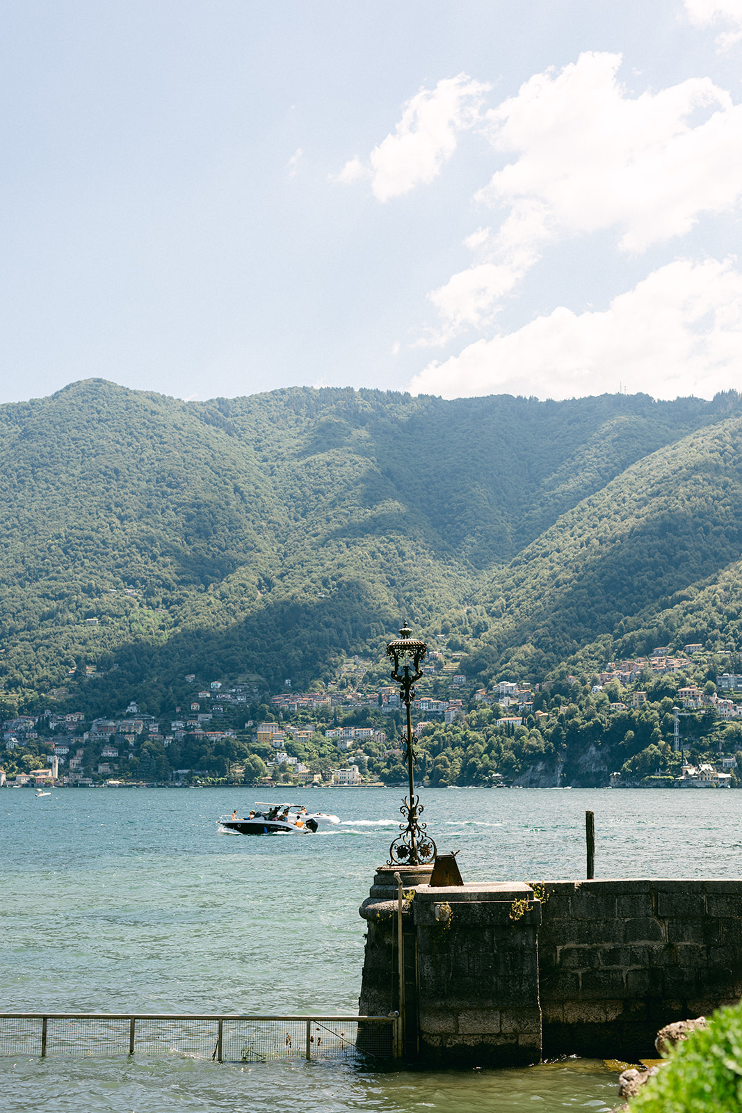 Lake Como and the surrounding mountains viewed from Villa Erba's waterfront.