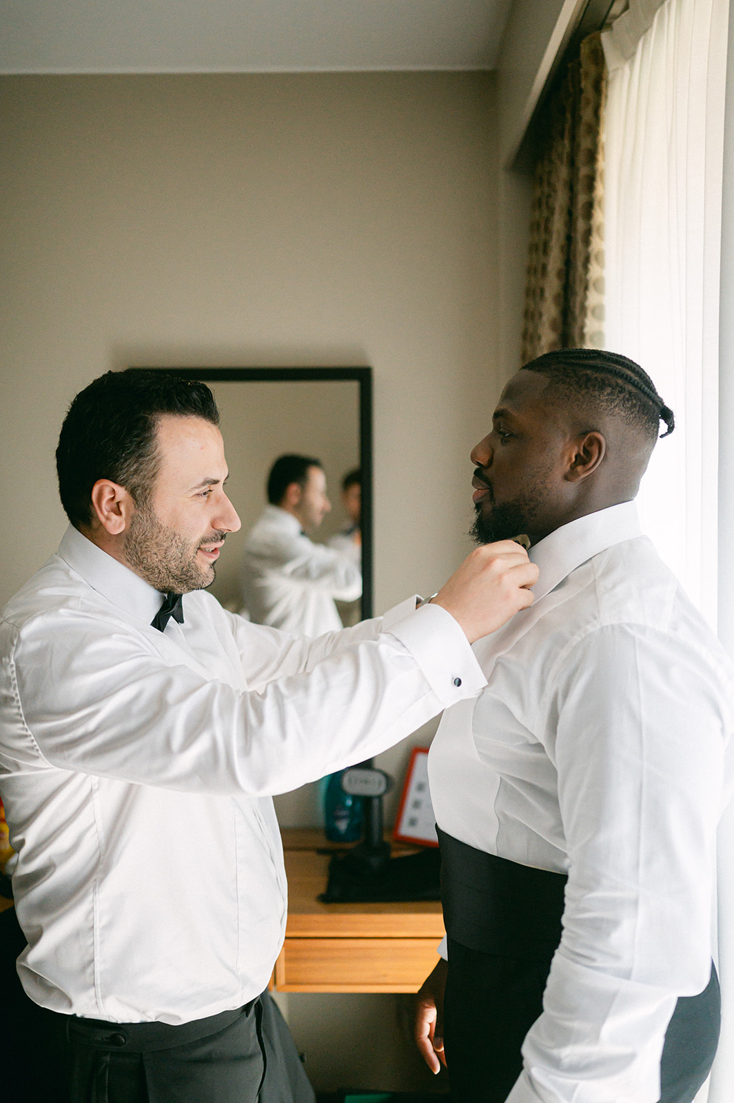 Ope having his bow tie adjusted during wedding preparations at Lake Como.