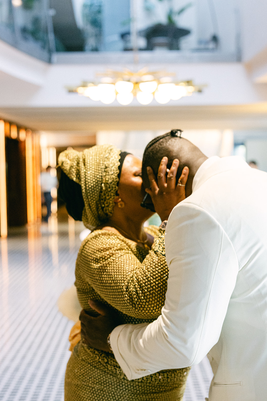 Ope greeting a guest with a kiss during his wedding preparations.