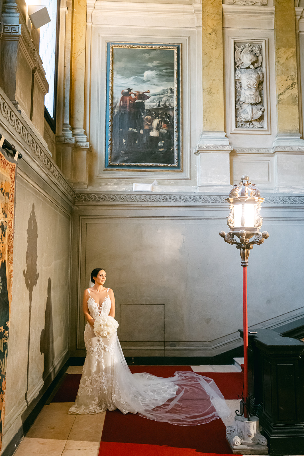 Fran posing in her wedding gown on the grand staircase of Villa Erba, Lake Como.