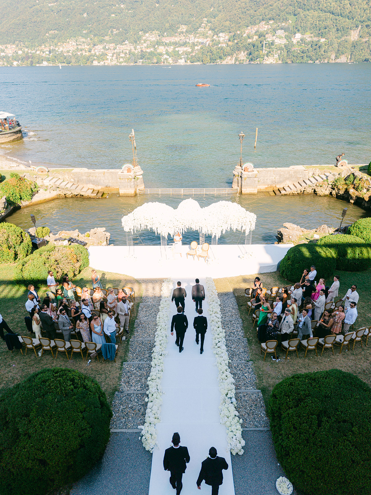 Aerial view of wedding guests gathering for Fran and Ope's lakeside ceremony at Villa Erba.