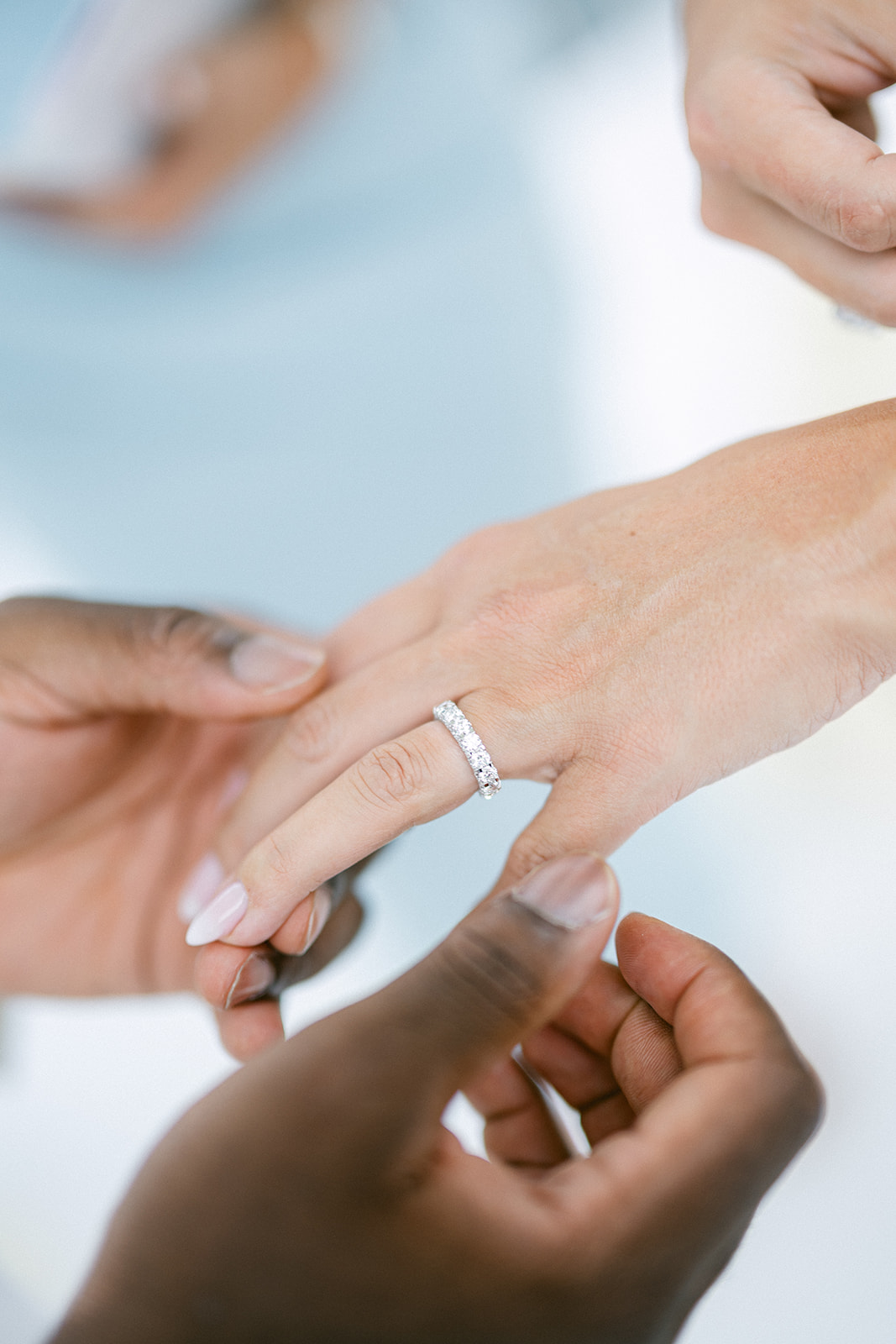 Close-up of Fran and Ope's hands during their wedding ring exchange.
