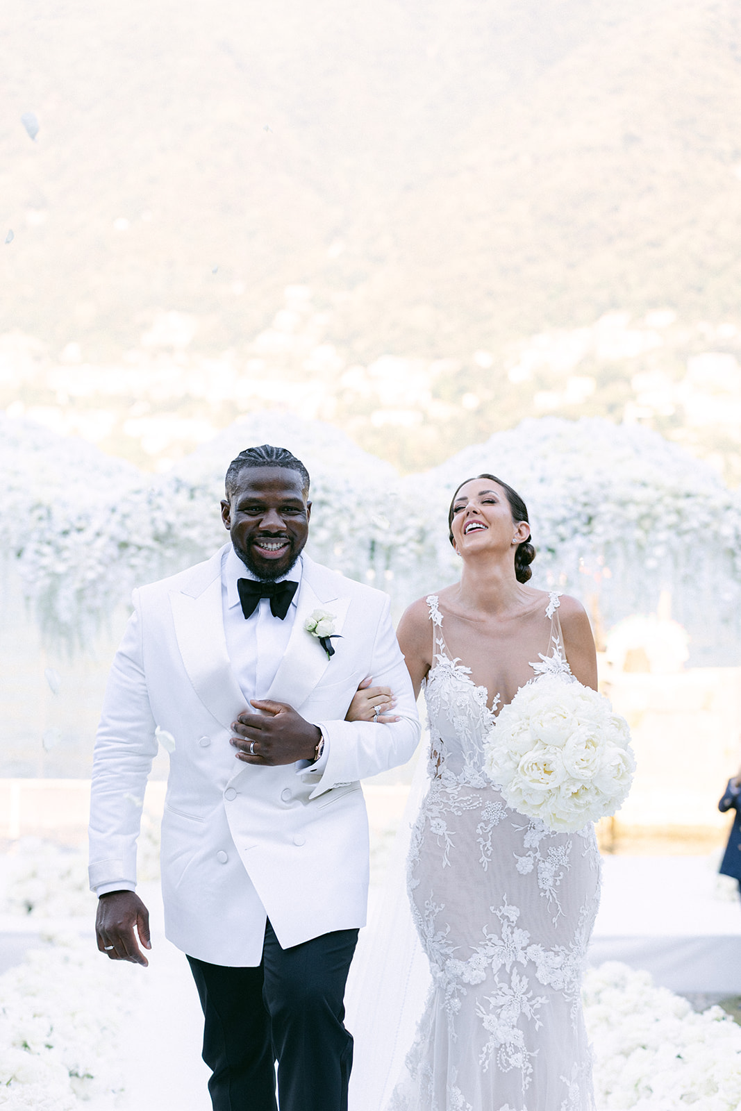 Fran and Ope walking down the aisle together after their wedding ceremony at Villa Erba.