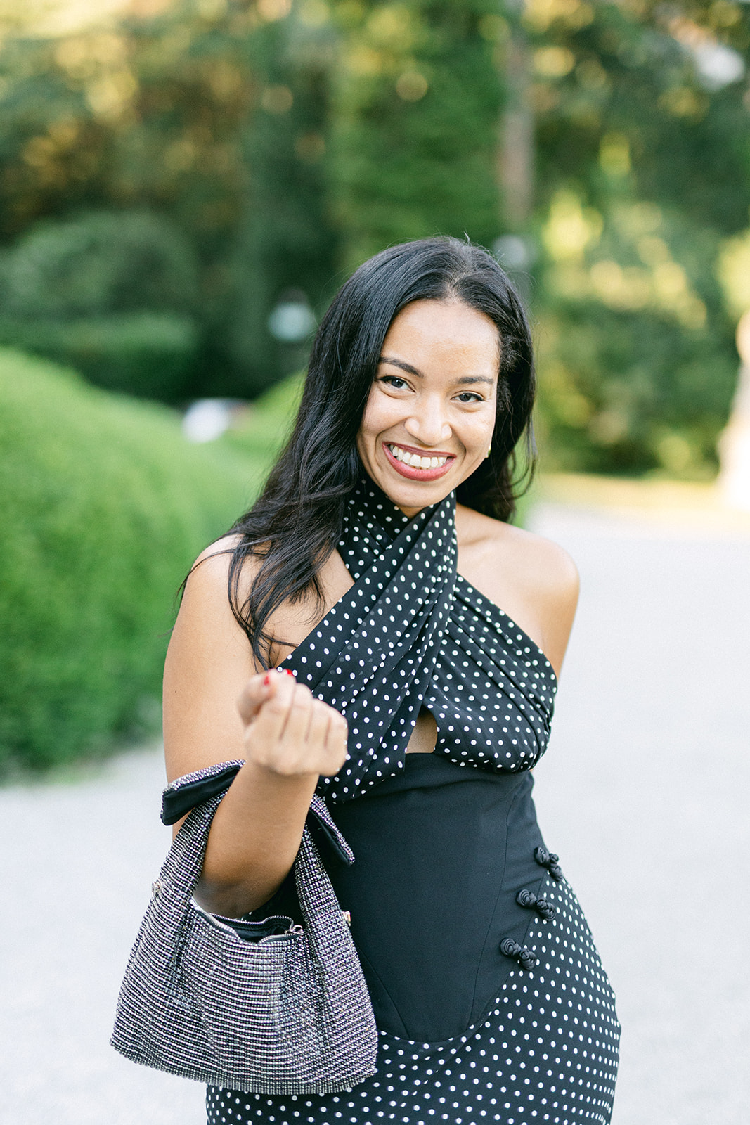 Smiling wedding guest in a black dress during the reception at Villa Erba.