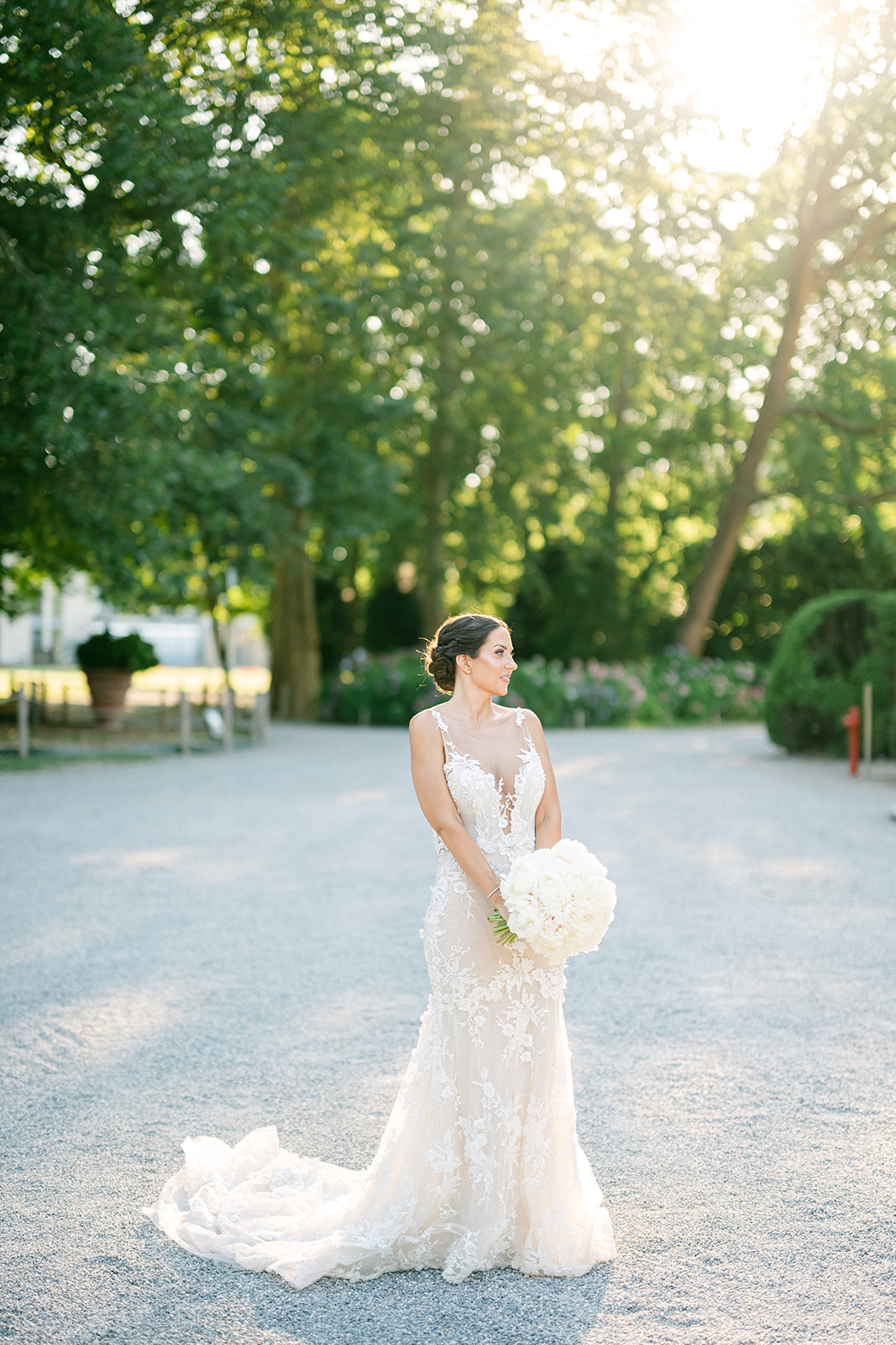 Fran holding her bridal bouquet in the gardens of Villa Erba in the evening light.