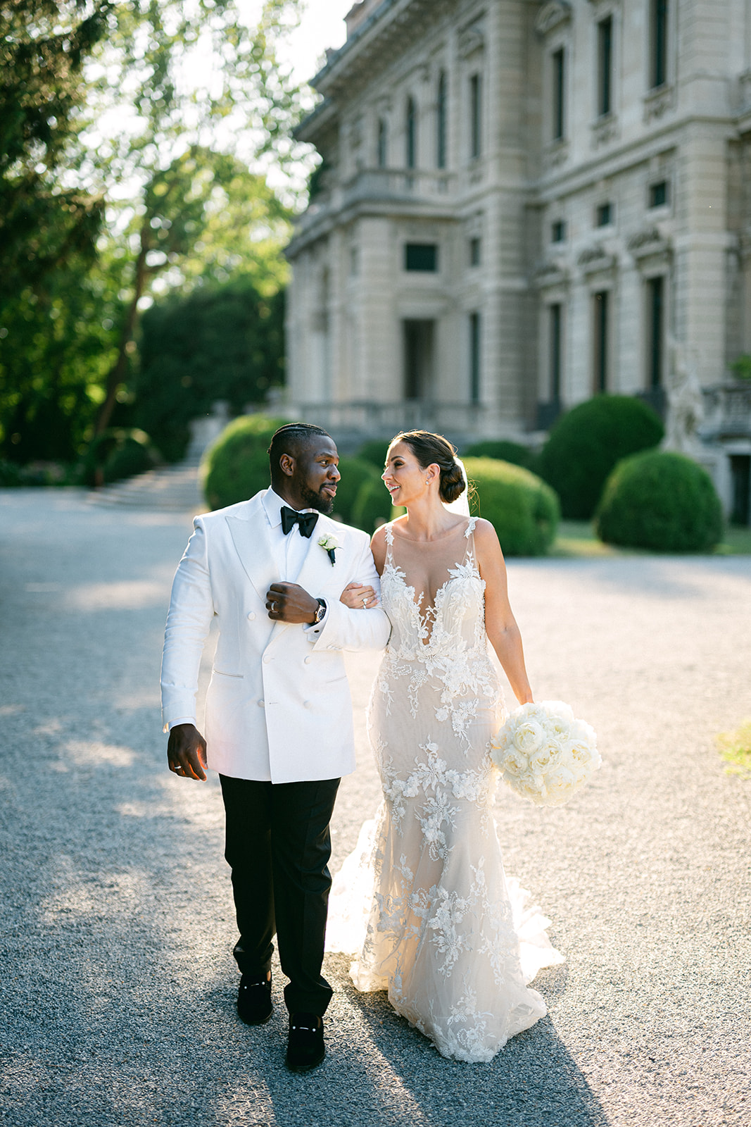 Fran and Ope walking together through the gardens outside Villa Erba.