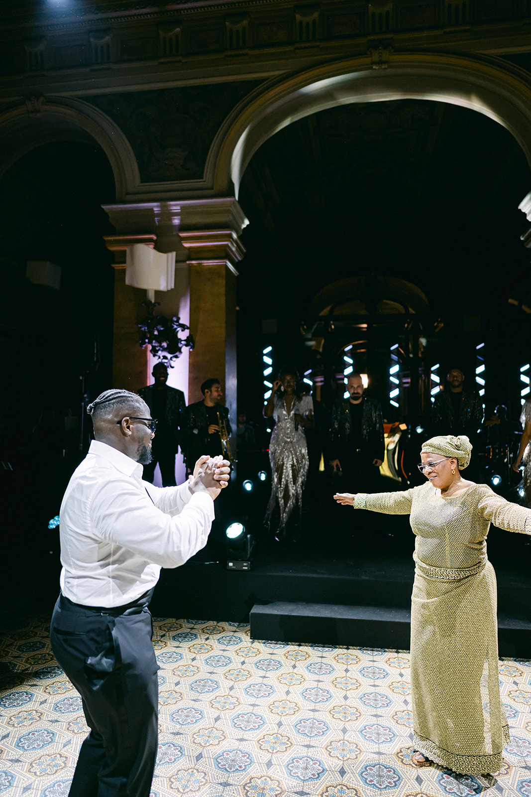 Ope dancing with a woman in a gold dress during the wedding celebration at Villa Erba.