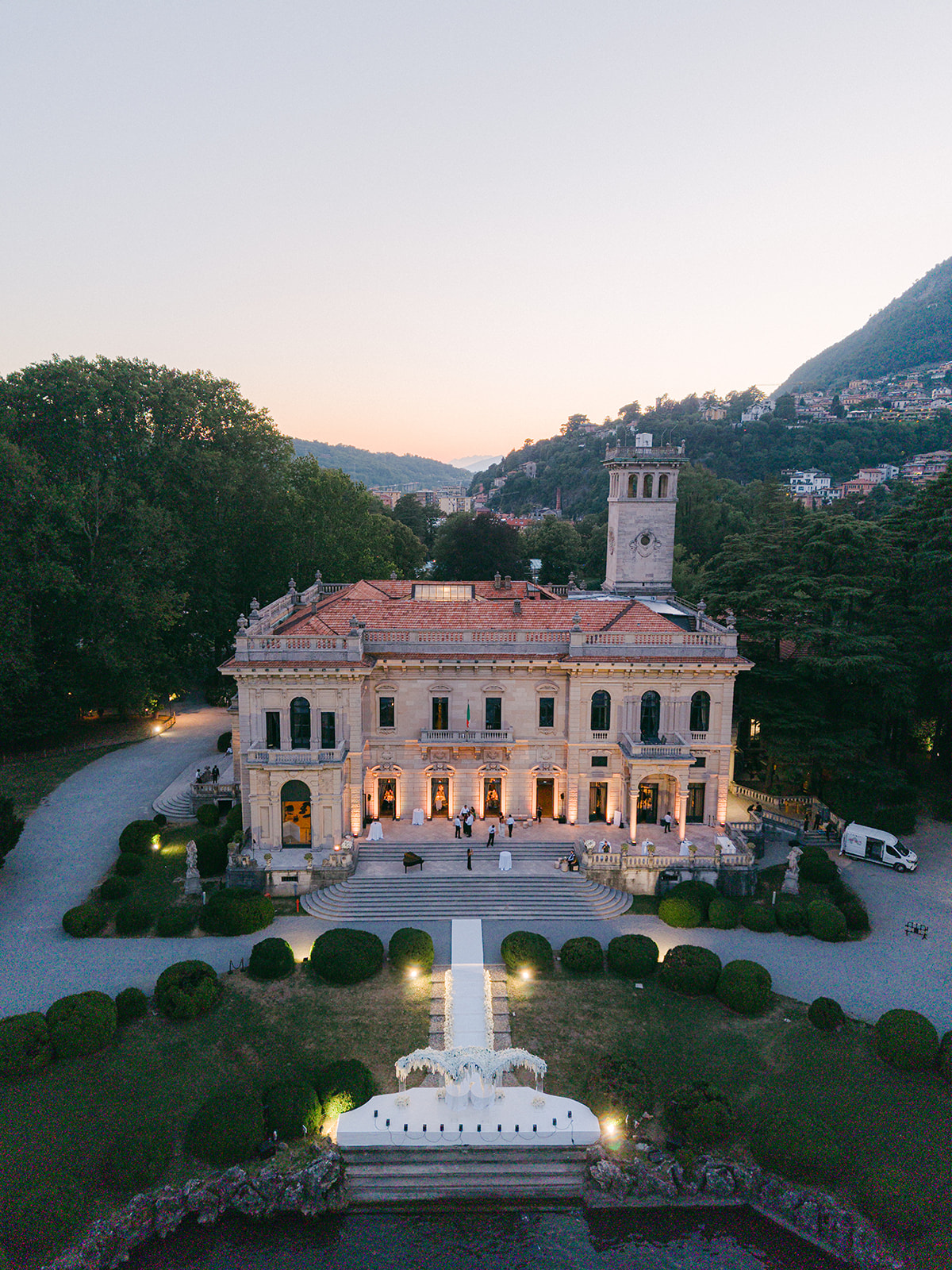 Aerial view of Villa Erba and its lakeside wedding setting at sunset.